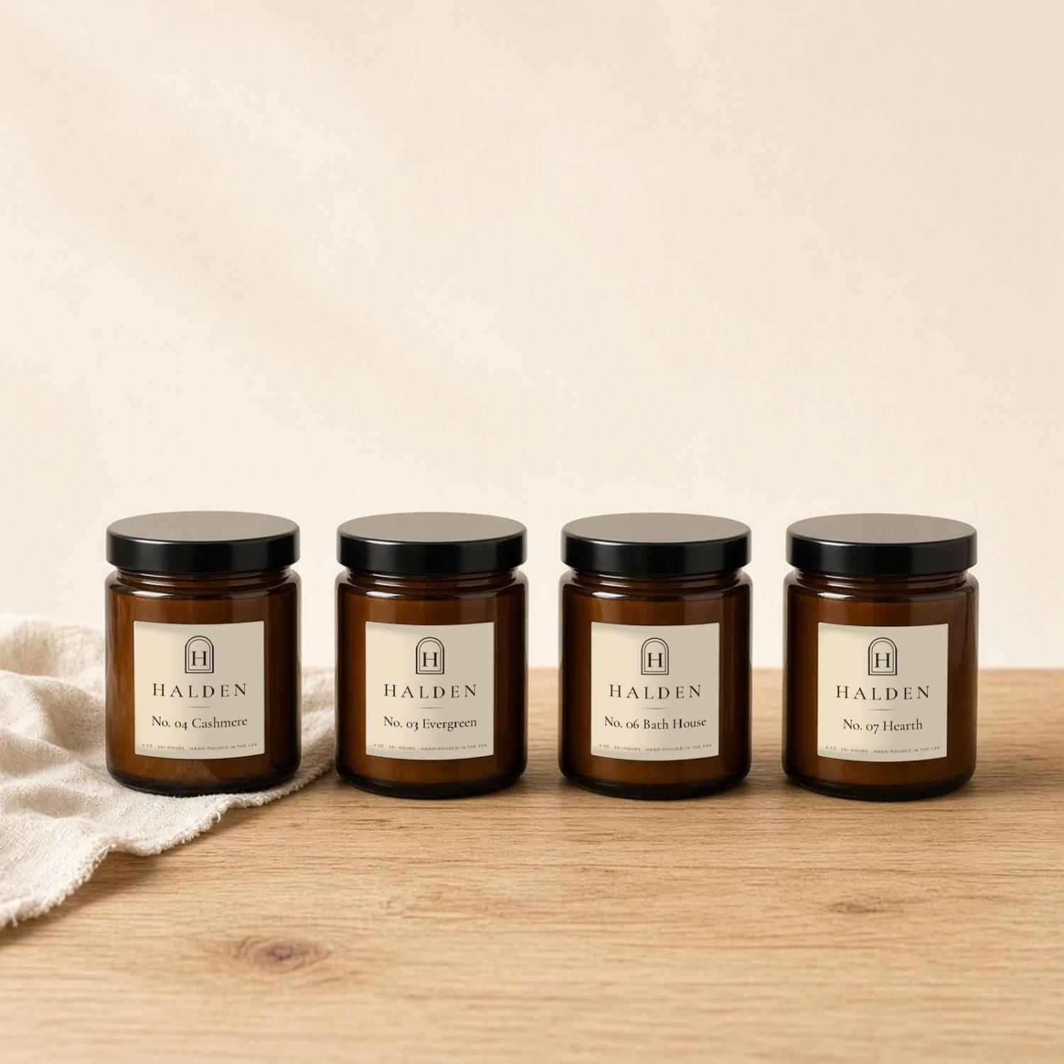 Four small Halden amber candles: Cashmere, Evergreen, Bath House and Hearth